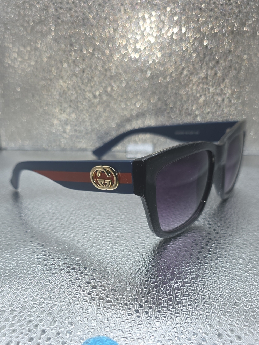 Sunglasses on reflective surface